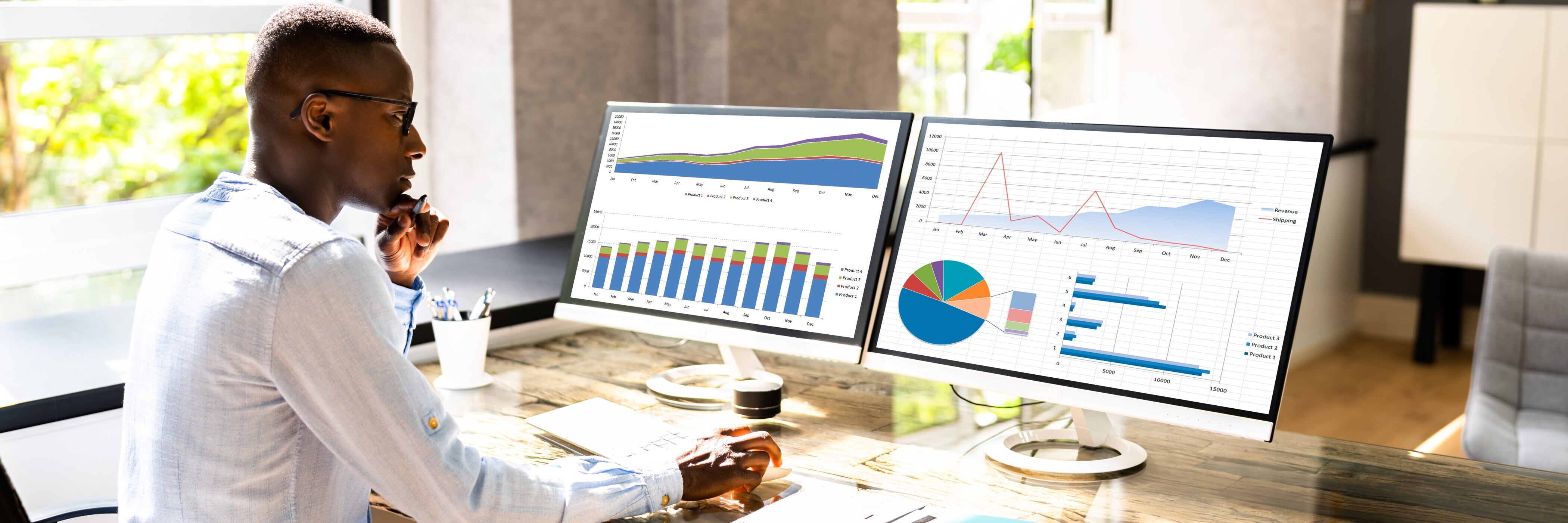 Businessman Looking At Graphs On Computer