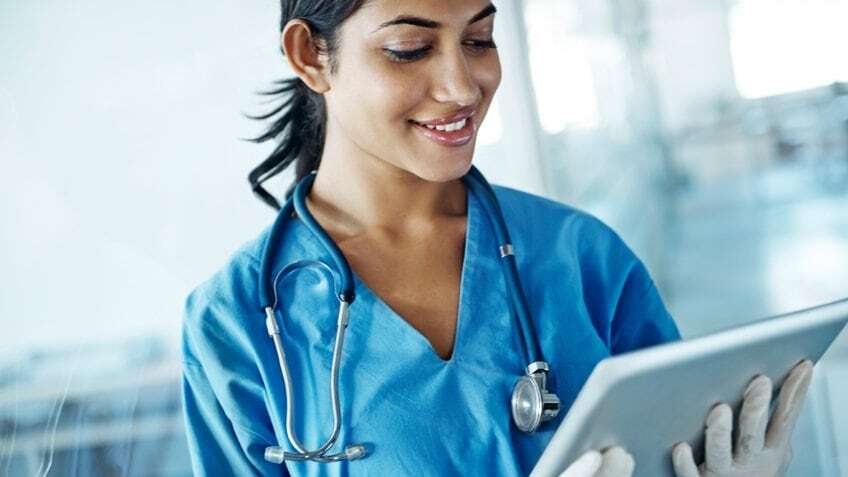 female doctor looking at tablet