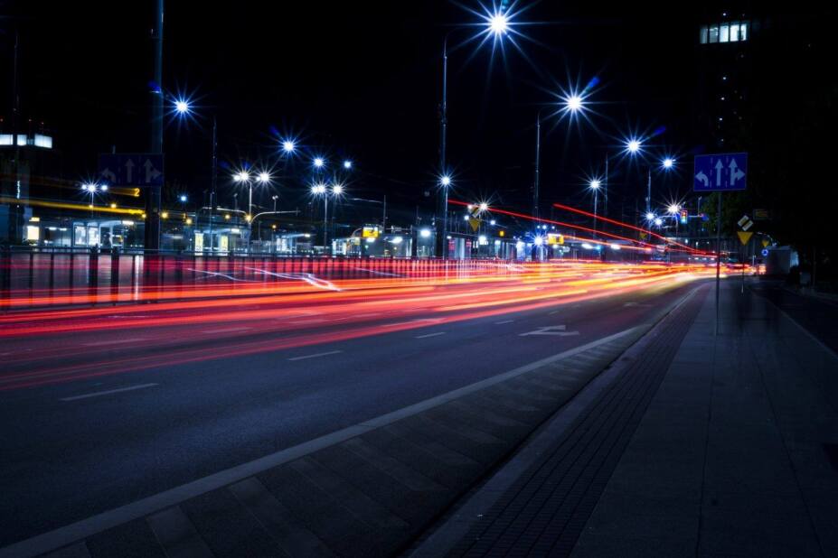 City street at night with blurred lights from the passing cars