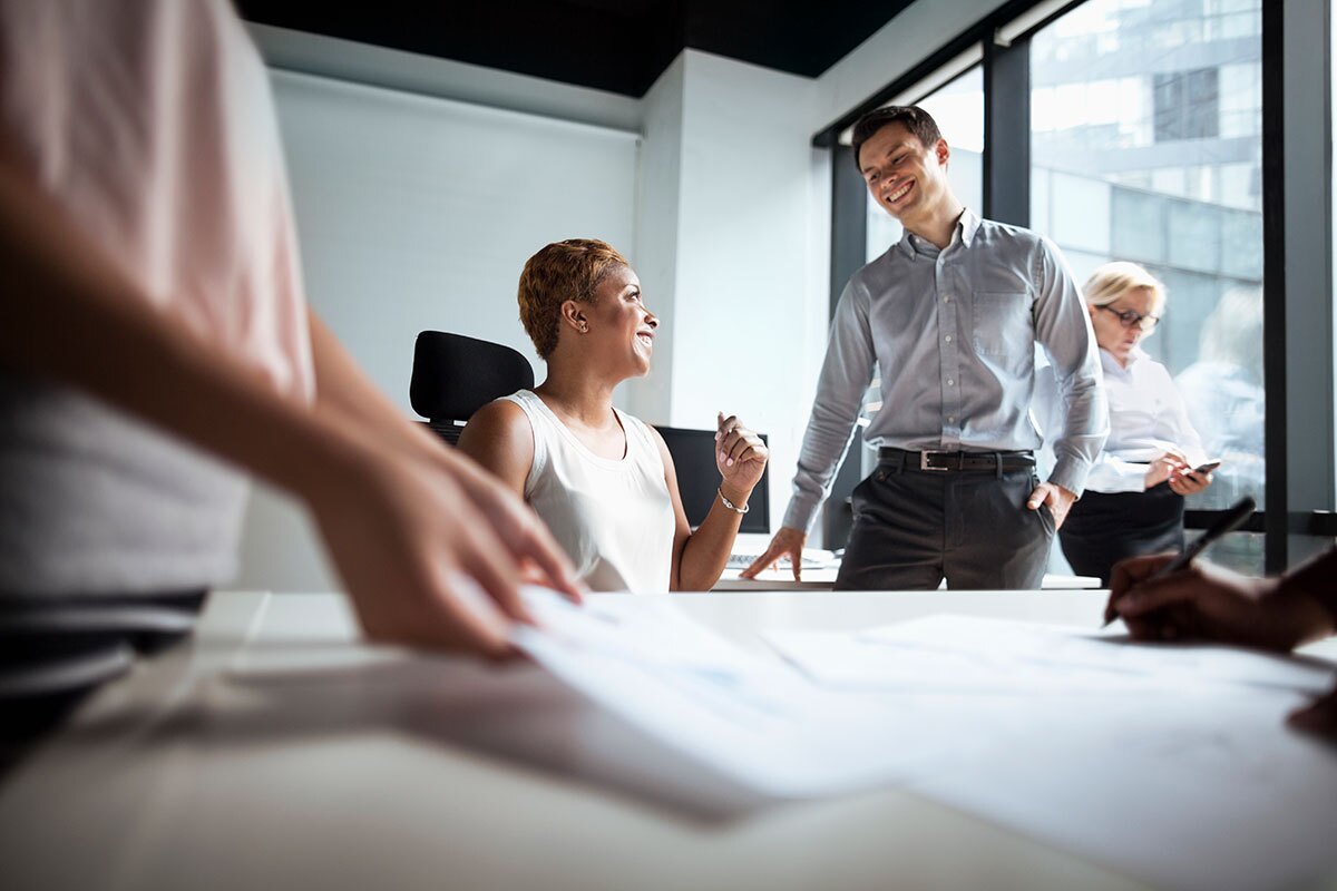 coworkers reviewing plans in a conference room in the office