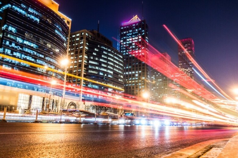 busy street in the middle of a city at night