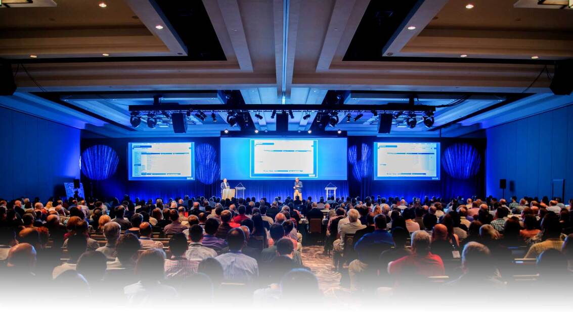 attendees of Global Summit 2016 listening to a presentation in a large conference room