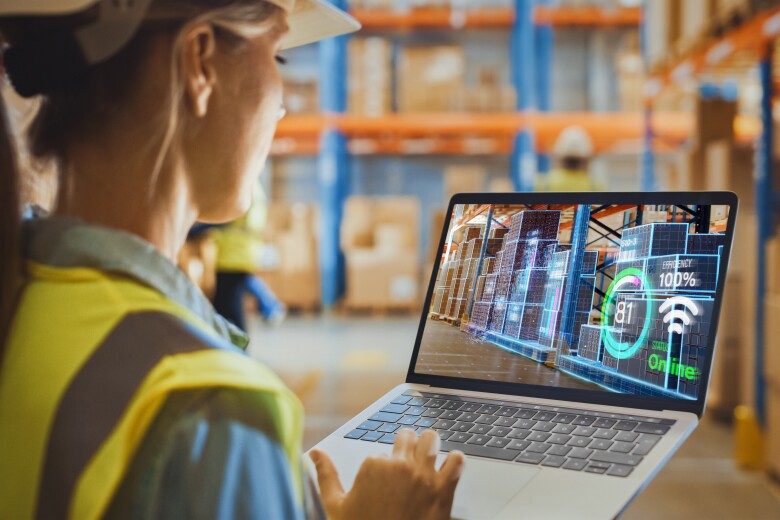 Futuristic Technology Warehouse: Female Worker Doing Inventory, Using Augmented Reality Program On Laptop Computer