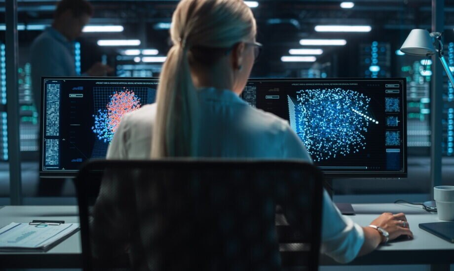Digital computer screen with women in front of monitor