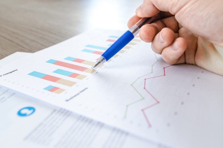 pen pointing to a chart in a book