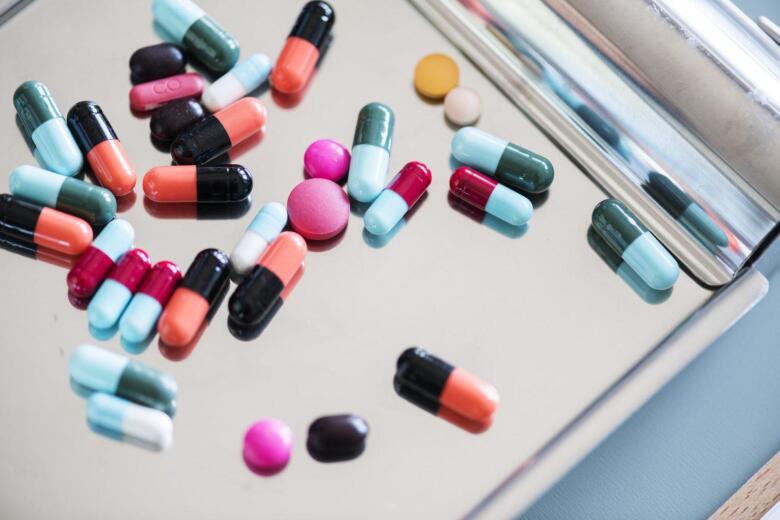 variety of pills, tablets and capsules on a tray
