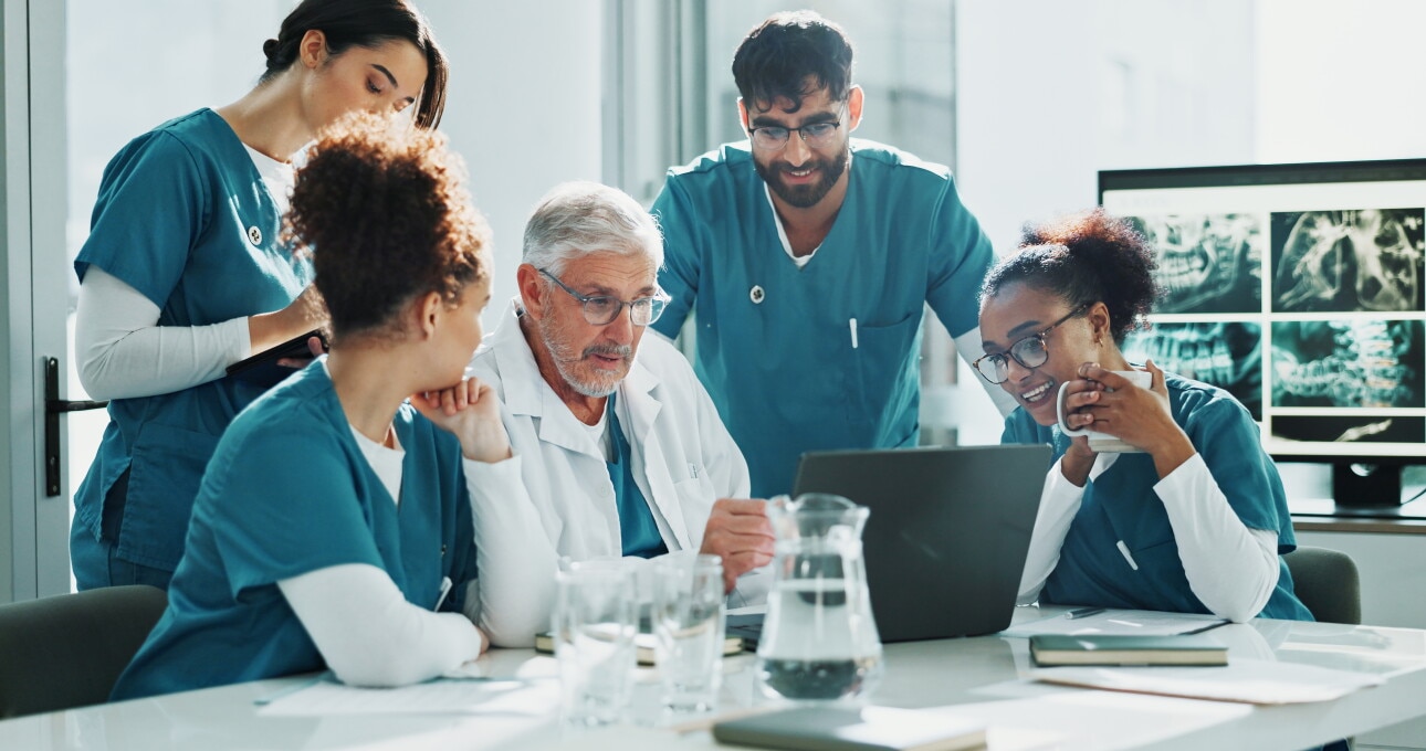 Doctor, nurses and meeting in hospital with laptop, discussion and medical research for diagnosis.