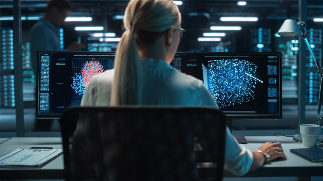 Digital computer screen with women in front of monitor
