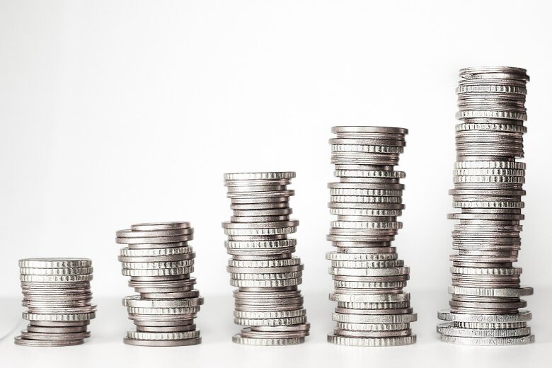 five stacks of silver coins ascending in height