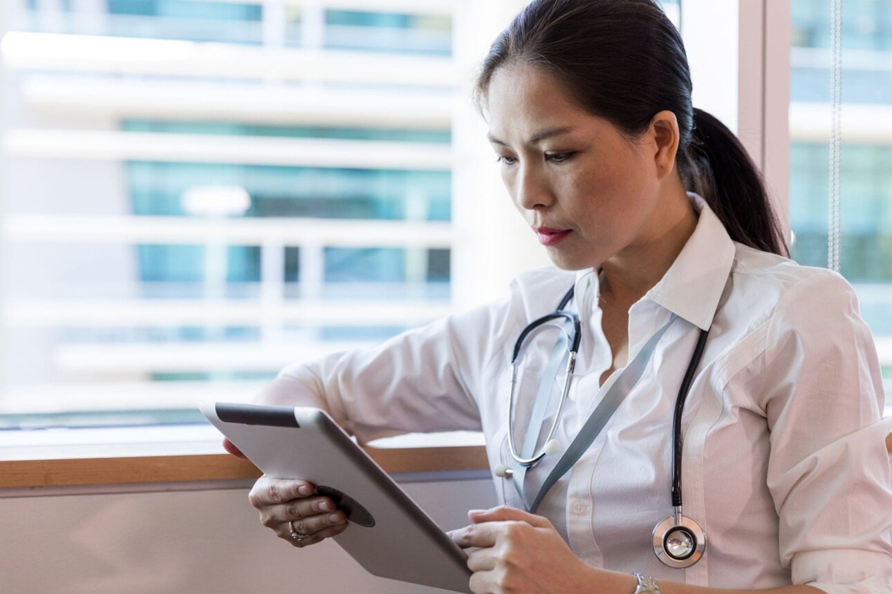 female doctor studying information on a tablet in the hospital