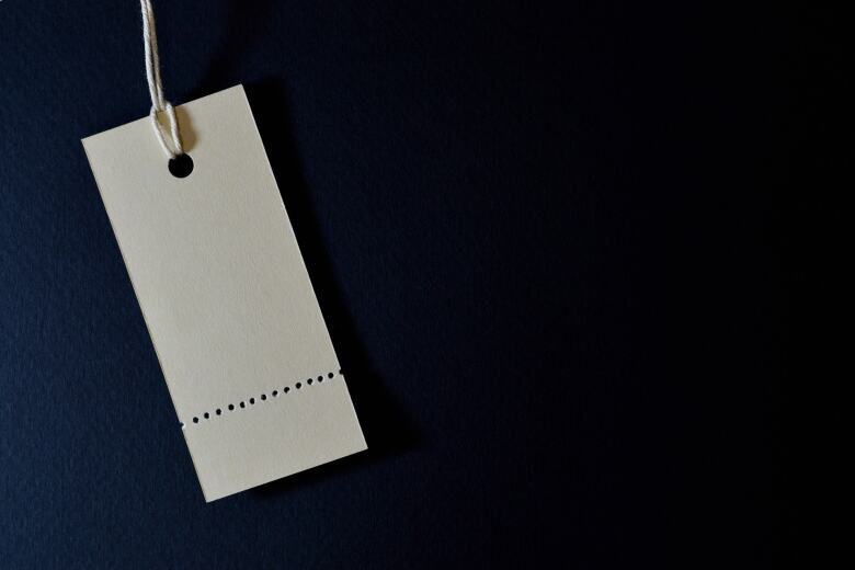 blank ivory price tag on dark background