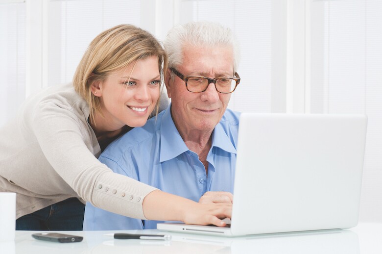 woman and man looking at laptop