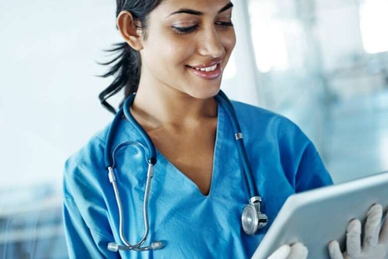 female doctor looking at tablet