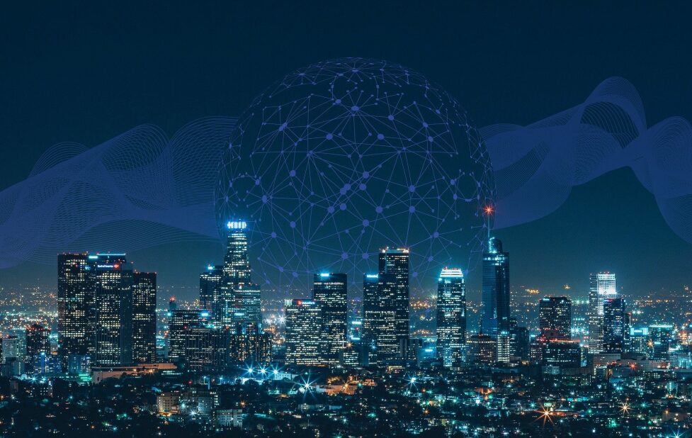 sphere of data points layered over the skyline of a city at night, representing big data