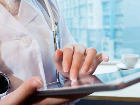female doctor scrolling on a tablet