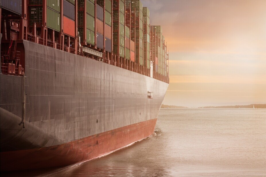 large container ship sailing on the water, approaching land