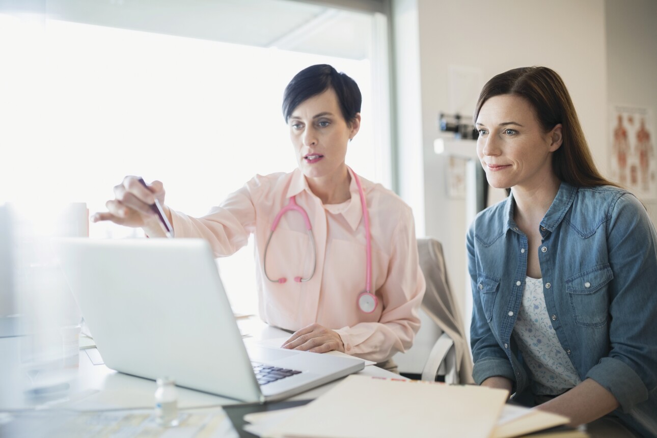 Doctor and patient in consultation at laptop