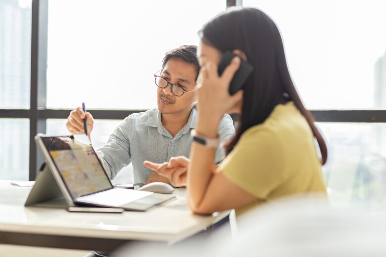 Business team collaborates on a financial report on a Microsoft Surface Pro