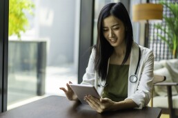 young female doctor using tablet in her office