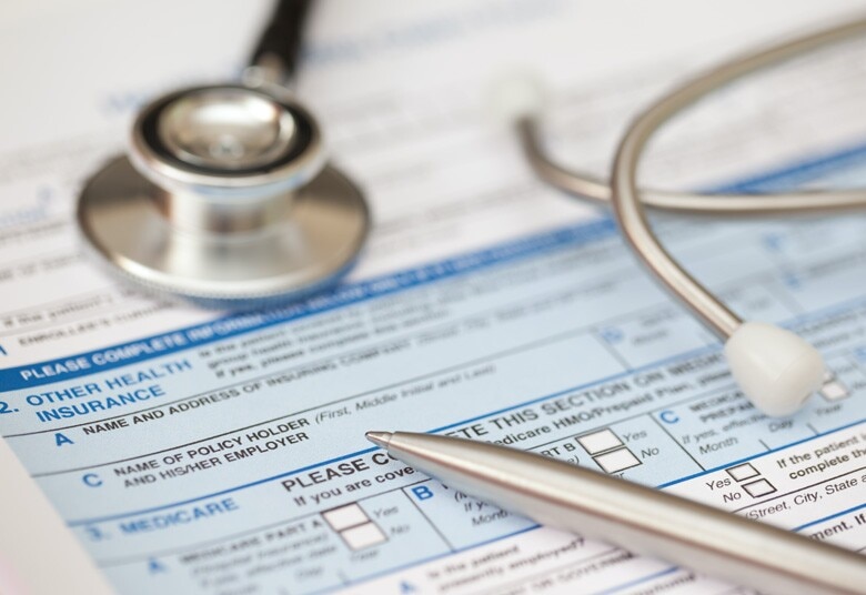 stethoscope and pen lying on a medical form