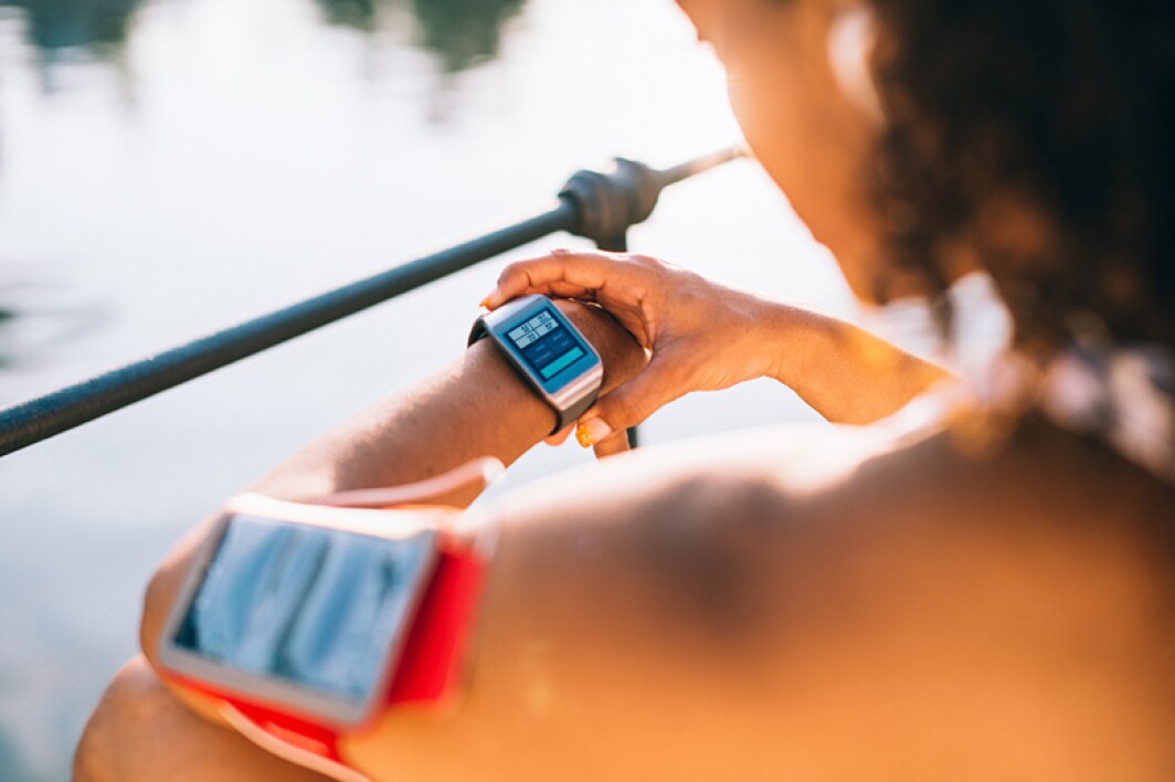 woman checking her smartwatch before her workout