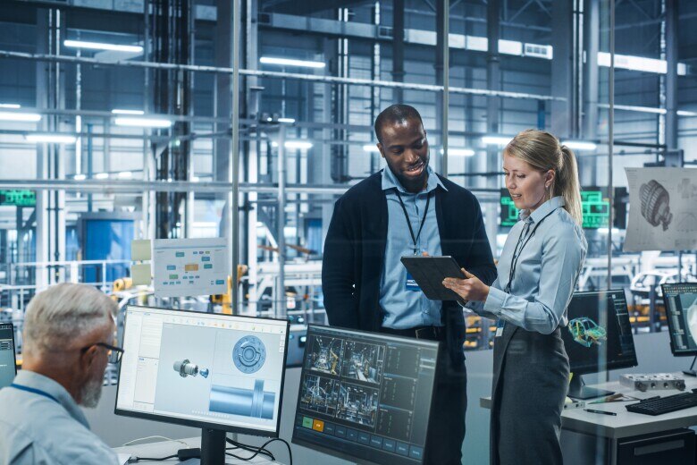 Car Factory Office: Female Engineer Talks with Male Scientist, Use Tablet Computer to Design Production Conveyor for Advanced Power Engines. Automated Robot Arm Assembly Line Manufacturing Vehicles