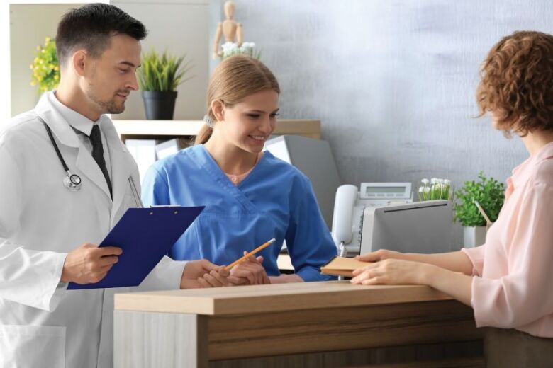 patient checking in at the reception desk in a doctor office