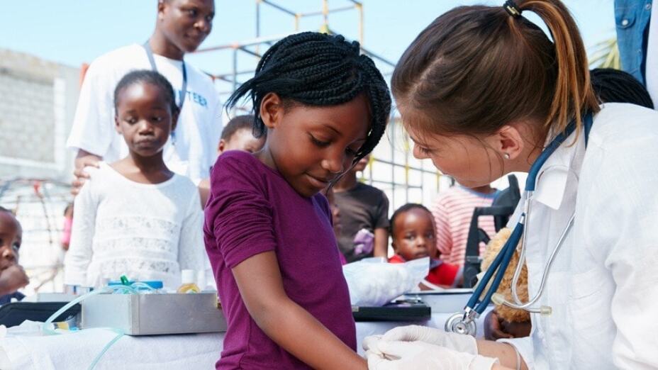 concerned doctor speaking with young child patient
