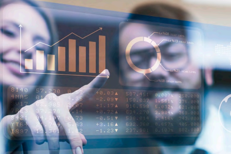 Two people looking at demand sensing and forecasting data