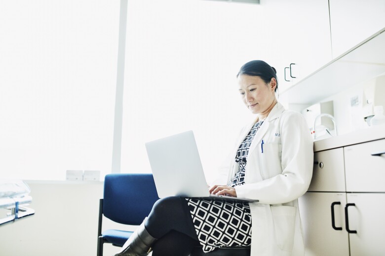 doctor working in office on laptop