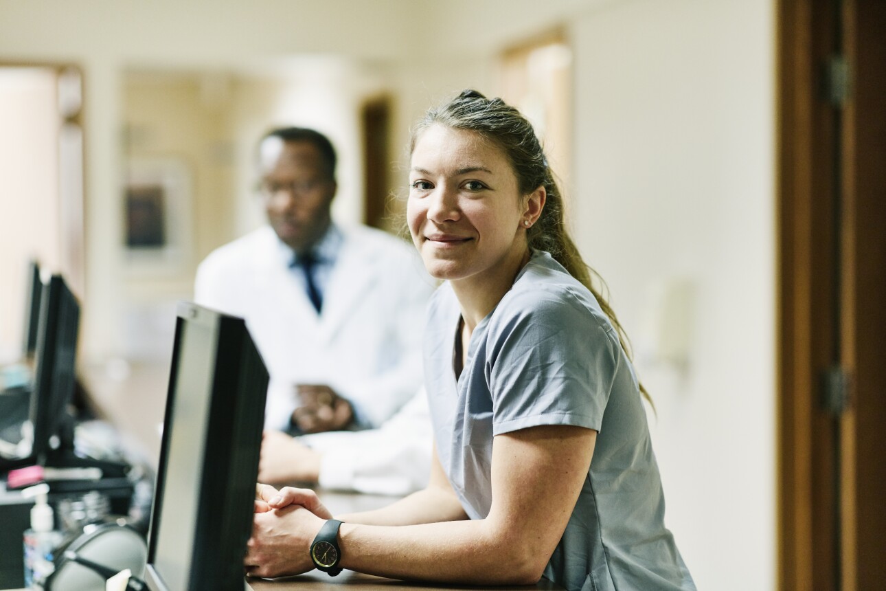 Portrait of smiling nurse at a nurses' station in hospital