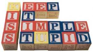 Classic children's blocks lined up to spell Keep It Simple Stupid, with the first letters, KISS, slightly separate