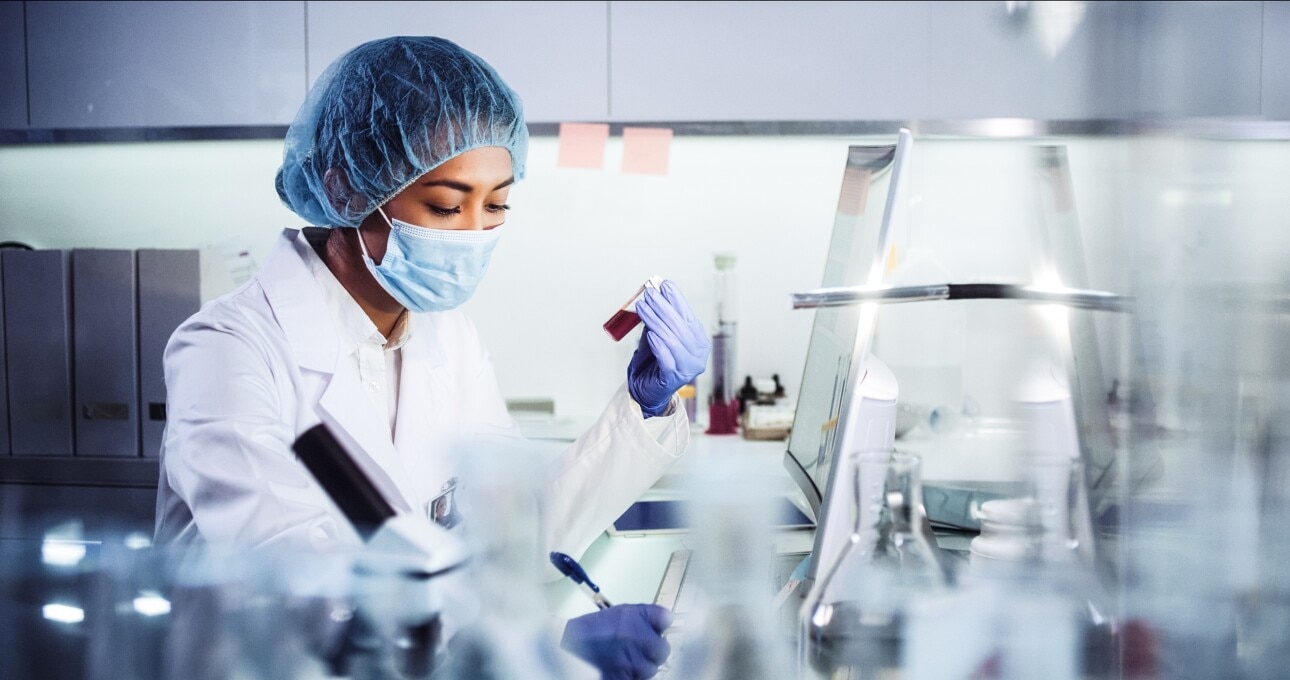 Asian female doctor working with pathogen samples. Using microscope