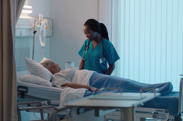 Doctor or Nurse at patient bedside