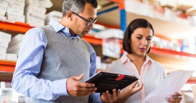 managers reviewing data in a warehouse