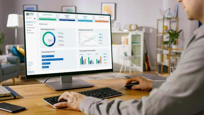 Man viewing various charts on computer monitor.