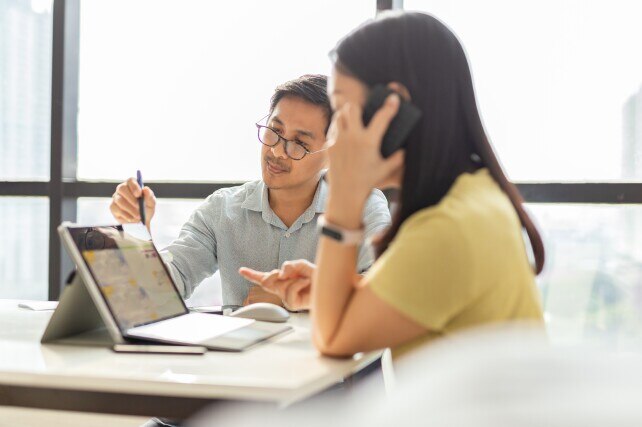 Business team collaborates on a financial report on a Microsoft Surface Pro