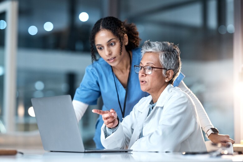 doctor and nurse looking at computer