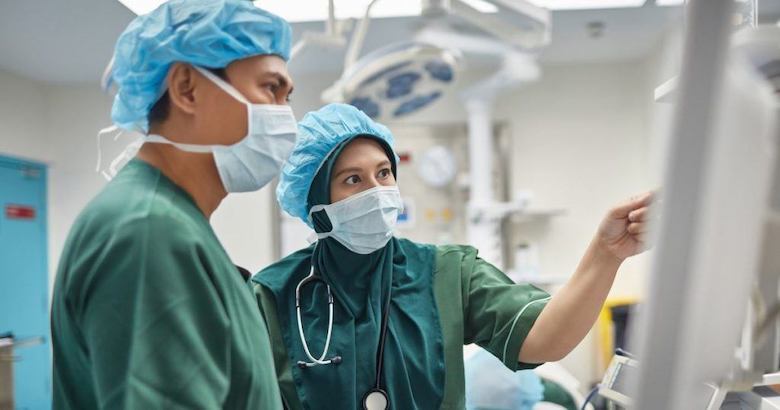 surgeons reviewing information on a computer