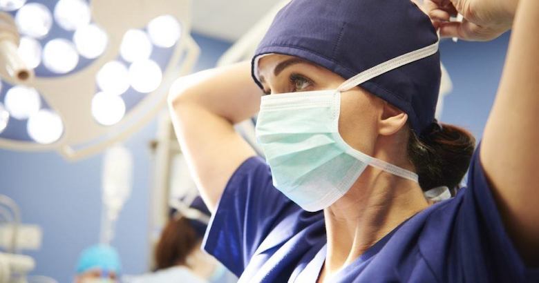 medical professional putting on a mask