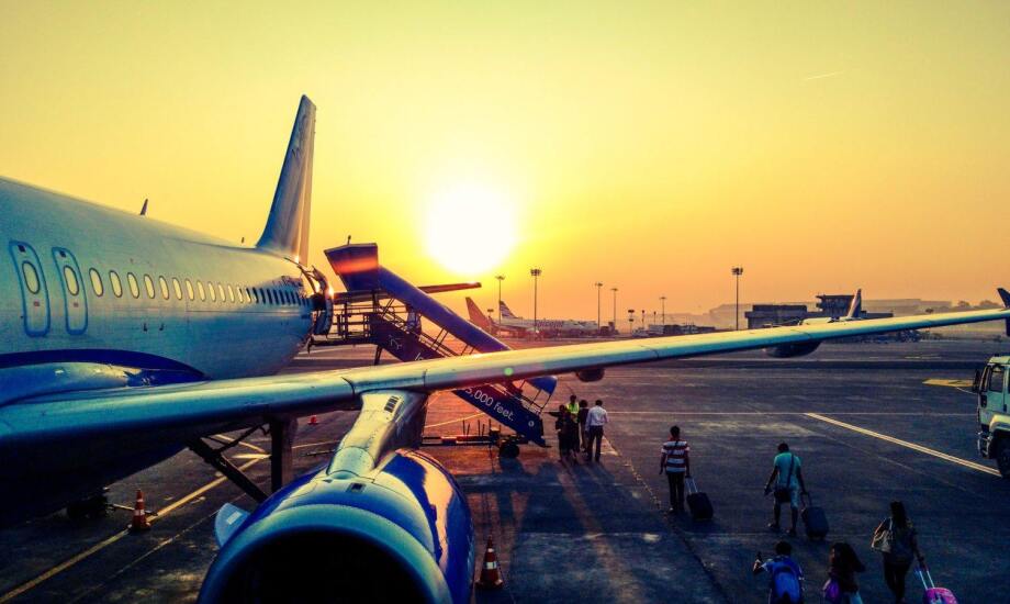 passengers boarding airplane from the tarmac