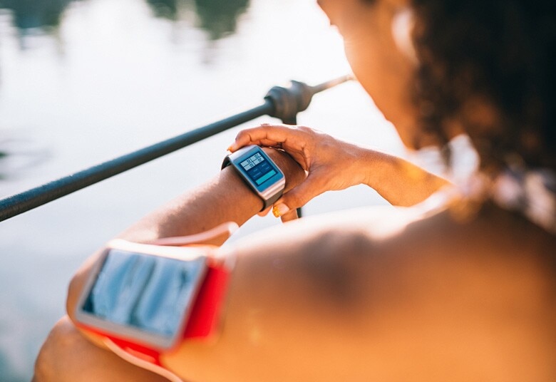 woman checking her smartwatch before her workout