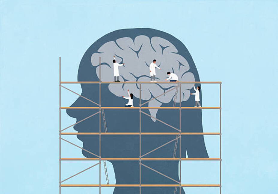 Scientists on scaffolding repairing brain in silhouetted girl's head