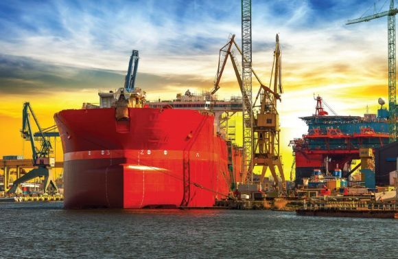 large cargo ship docked in a busy port