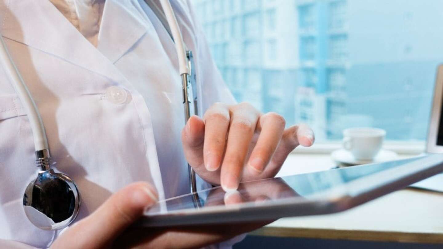 female doctor scrolling on a tablet