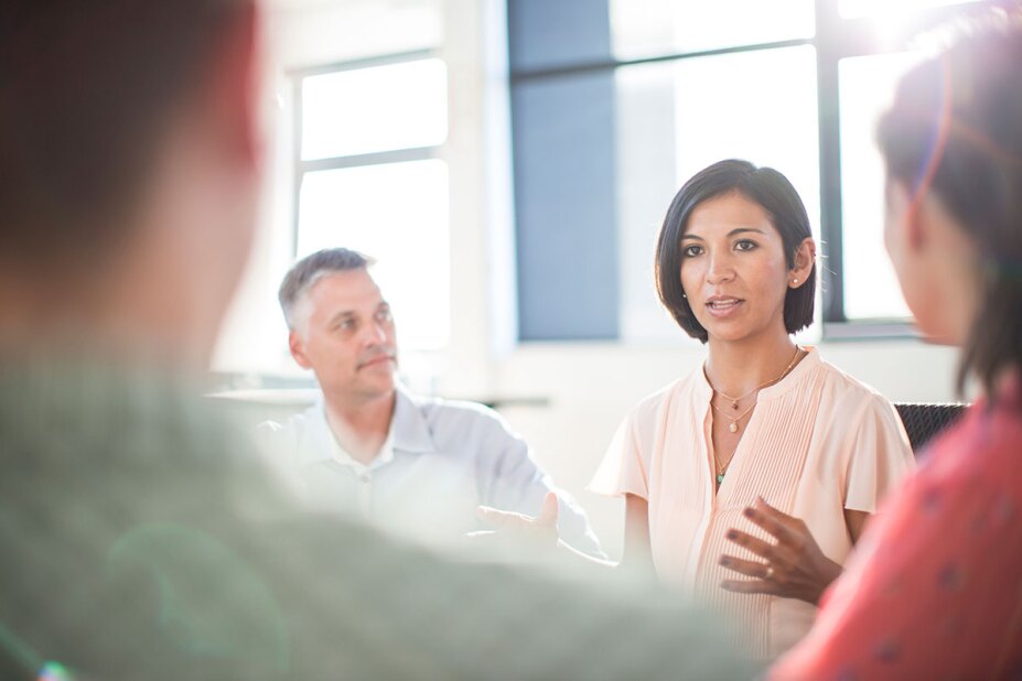 woman speaking during business meeting