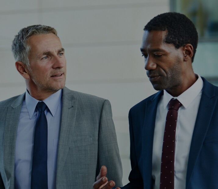Two business analysts walking during discussion