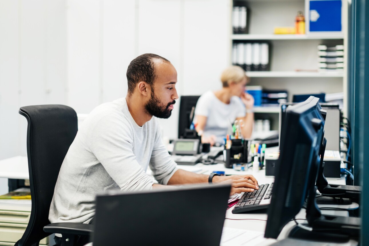 Male software developer sitting at his desk typing