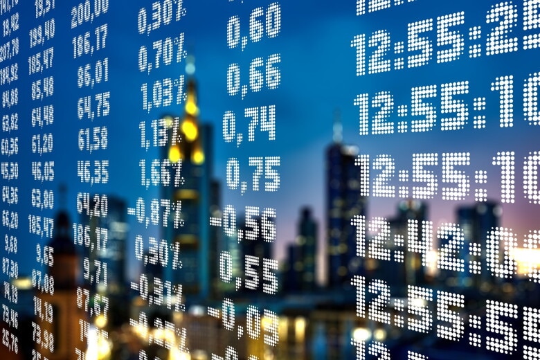 stock exchange screen reflecting city skyline