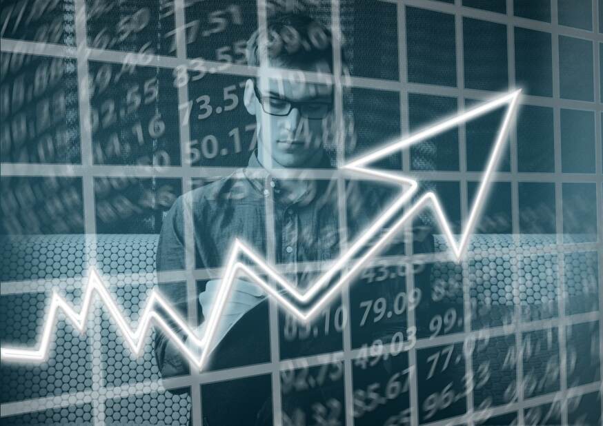 layered image showing a young professional, financial data and line graph on the rise